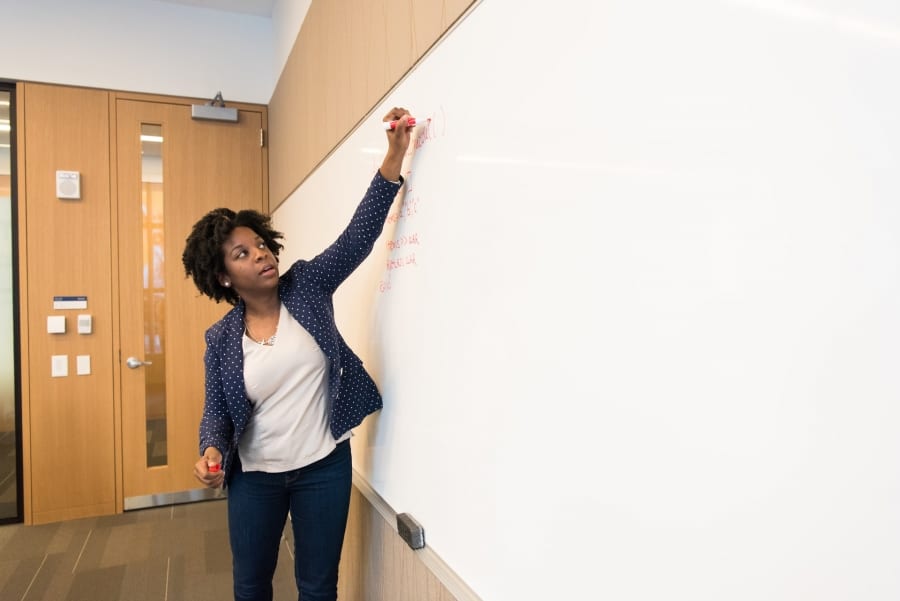 Girl writing on the white board